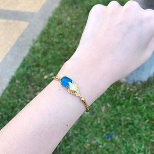 Gold plated bracelets metal with blue stone.